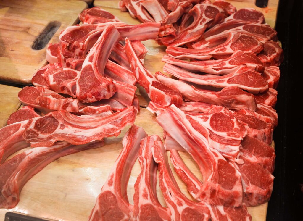 large amount of lamb chops laid out on a board