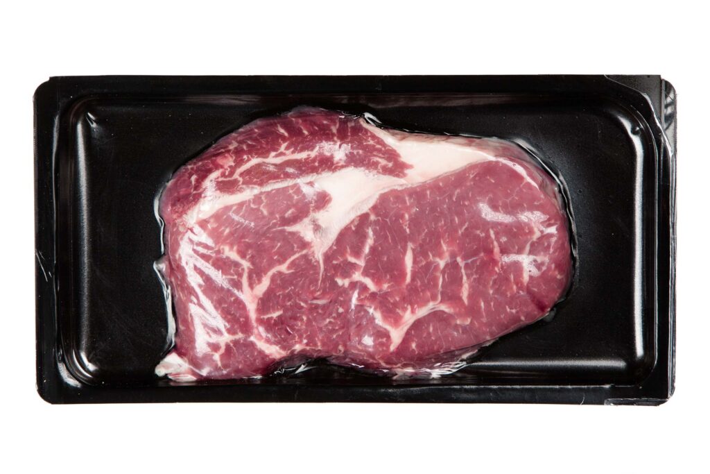 a cut of beef in a tray formed package